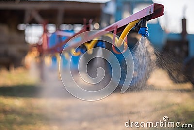 Tractor sprinkles the pesticides Stock Photo