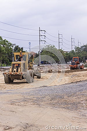 Tractor with Steamroller road roller leveling Stock Photo