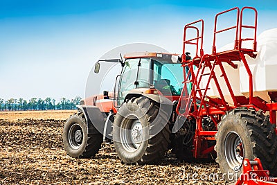 Tractor with tanks in the field. Agricultural machinery and farming. Stock Photo