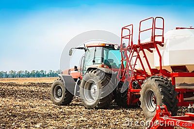 Tractor with tanks in the field. Agricultural machinery and farming. Stock Photo