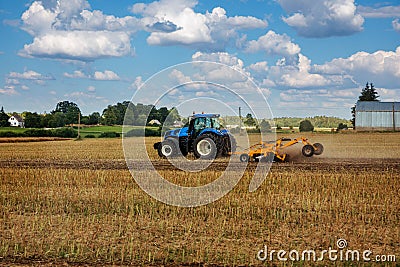 A tractor tillage of an agricultural field Stock Photo