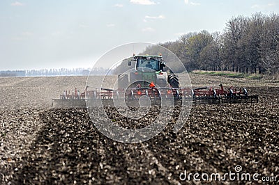 Tractor with trailed planter on the field Editorial Stock Photo