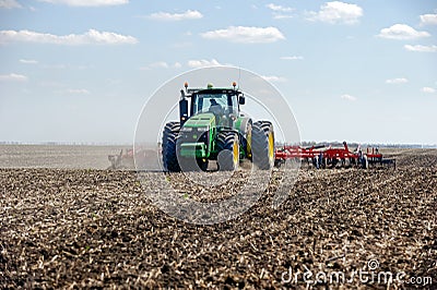 Tractor with trailed planter on the field Editorial Stock Photo