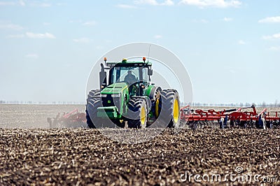 Tractor with trailed planter on the field Editorial Stock Photo