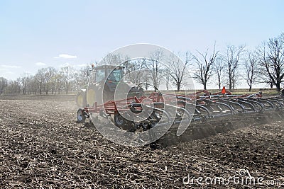 Tractor with trailed planter on the field Editorial Stock Photo