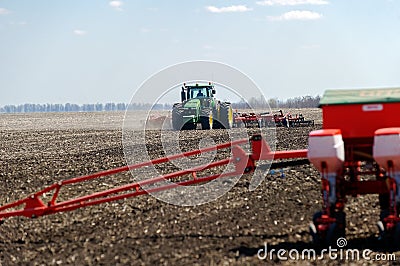 Tractor with trailed planter on the field Editorial Stock Photo