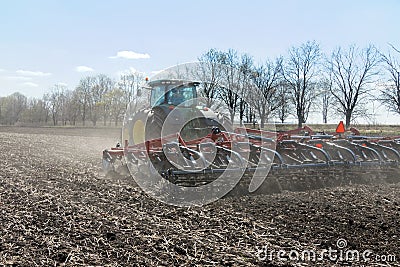 Tractor with trailed planter on the field Editorial Stock Photo