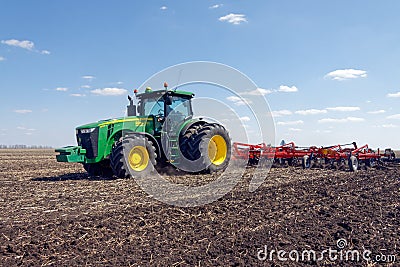 Tractor with trailed planter on the field Editorial Stock Photo