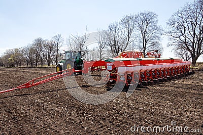 Tractor with trailed planter on the field Editorial Stock Photo