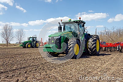 Tractor with trailed planter on the field Editorial Stock Photo