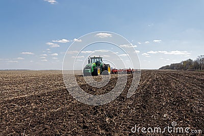 Tractor with trailed planter on the field Editorial Stock Photo