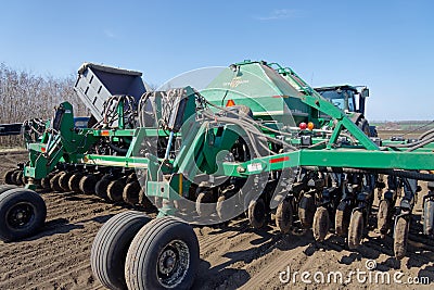 Tractor with trailed seeder on the field Editorial Stock Photo