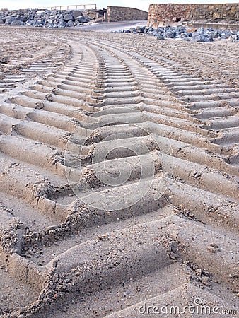 Tractor tyre tracks on the beach Stock Photo
