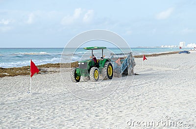 Tractor working at beach to clean sand Editorial Stock Photo