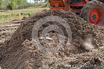 Tractors plow the land is adjusting to a class of the field. Stock Photo