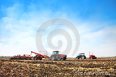 Tractors with tanks in the field. Agricultural machinery and farming. Stock Photo