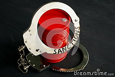 Trade embargo and sanctions. Barrel of oil and handcuffs Stock Photo
