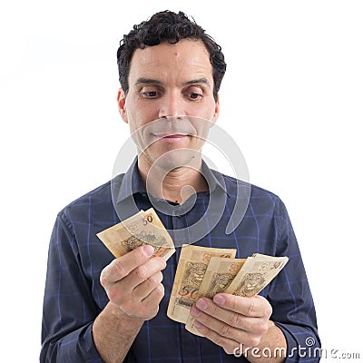 Trader is counting money. Currency: Real. The person is wearing Stock Photo