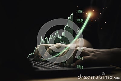 Trader using computer laptop with increasing virtual investment graph and chart for stock market analysis trend and technical by Stock Photo