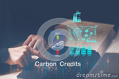 Trader using computer laptop to trade carbon credit on application. Net zero emission, Clean technology, Stock Photo
