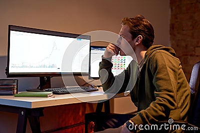 Trader watching and monitoring stock market chart Stock Photo