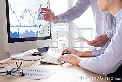 Traders discussing trading strategy, profit and ROI, stock market charts Stock Photo