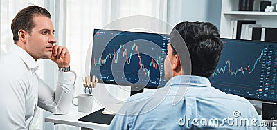 Traders discussing with two market stock screen on panorama view,. Sellable. Stock Photo