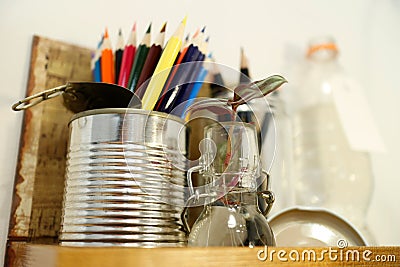 Tradescantia Zebrina cutting. Metal tin can reused as pencil holder. Filled with color pencils. Stock Photo