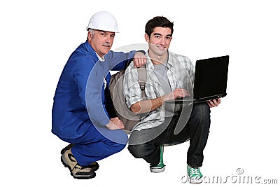 A tradesman helping his apprentice Stock Photo