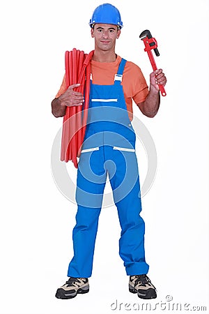 Tradesman holding corrugated tubing Stock Photo