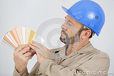 Tradesman holding fanned out colour samples Stock Photo