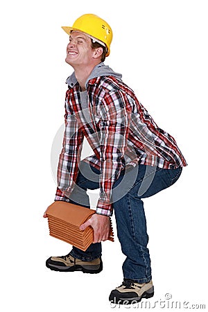 Tradesman lifting a heavy load Stock Photo