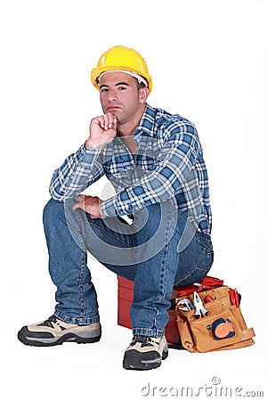 Tradesman sitting on toolchest Stock Photo