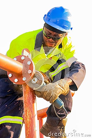 Tradesman working with an angle grinder on a building site Editorial Stock Photo