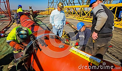 Tradesman working with welding torch Editorial Stock Photo