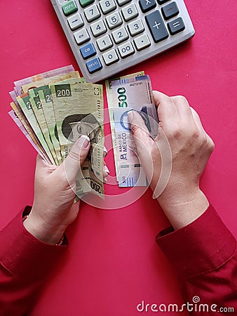 hands of a businesswoman counting mexican banknotes Stock Photo