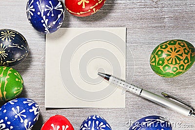 Tradition hand made easter egg with pen and blank paper fot text Stock Photo