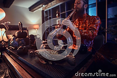 Tradition, health, harmony. Chinese tea ceremony. Tea master in kimono performs in the dark room with a wooden interior Stock Photo