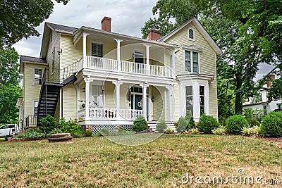 traditional American two-story house with a veranda and lawn at the entrance Editorial Stock Photo