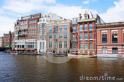 Traditional Amsterdam buildings on a canal, canal-side houses on water Editorial Stock Photo