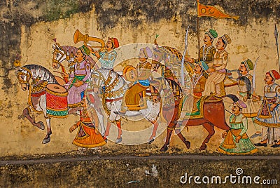 Traditional ancient stile indian wall painting on the old plastered wall in Udaipur, India