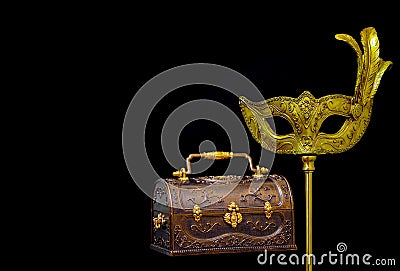 Ornate antique jewelry box and vintage venetian masquerade mask on a stick Stock Photo