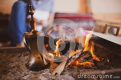 Traditional arabic coffee pot named dallah in fireplace Stock Photo