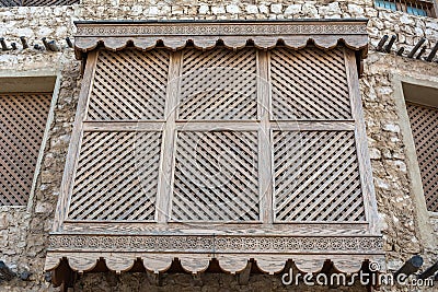 Traditional Arabic mashrabiya balcony enclosed with carved wood latticework Stock Photo