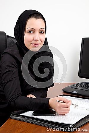 Traditional Arabic young woman at the office Stock Photo
