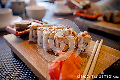 Traditional Asian food sushi on wooden plate. Stock Photo