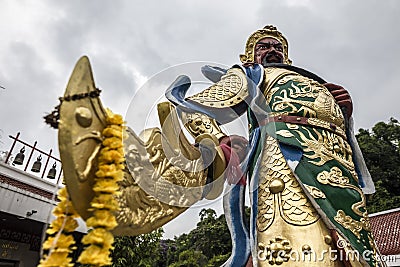 Traditional asian monument at temple with dragon and buddha located in Hat Yai Thailand Stock Photo