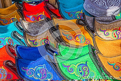 Traditional Asian shoes made of multicolored felt with embroidered colored thread of national ornament. Stock Photo