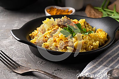 Traditional azian pilaf served in plate on gray background Stock Photo