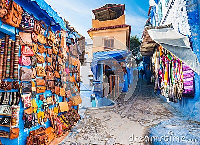Traditional bags, carpets and handicrafts on the street of Chefchaouen, Morocco Editorial Stock Photo